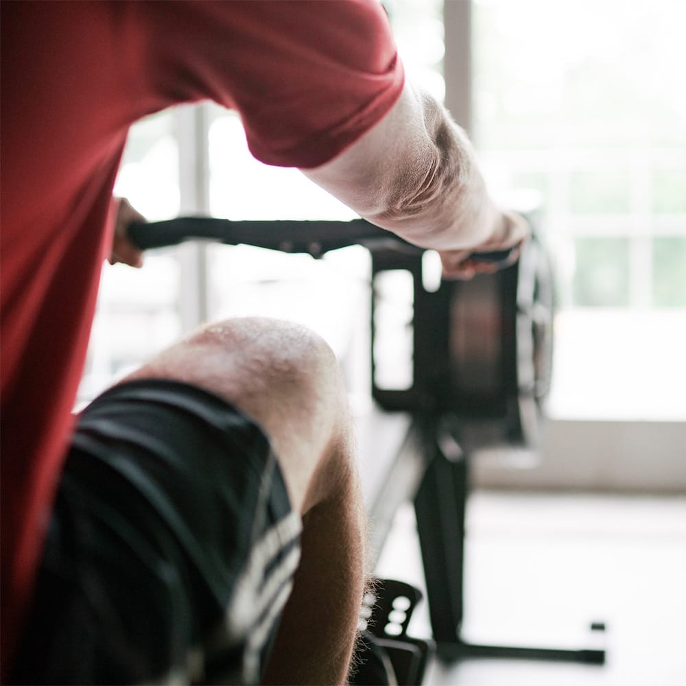 Home 1 man exercising at the gym with a rowing machine
