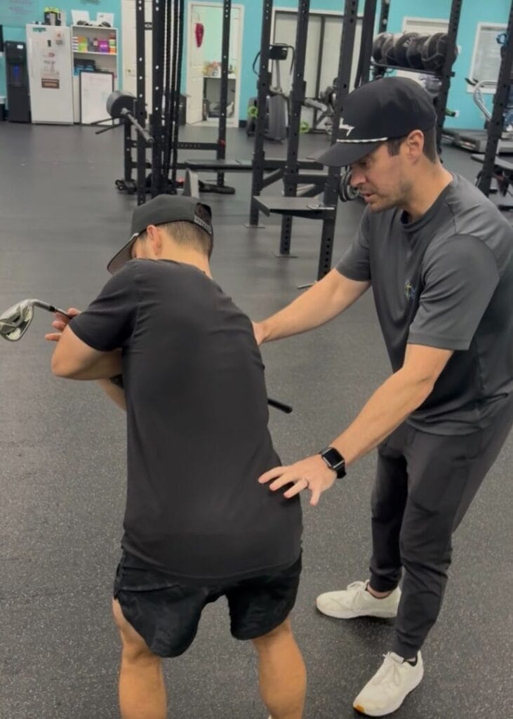 Cody with Active Family PT Working with Blayne on golf specific exercises to improve his swing